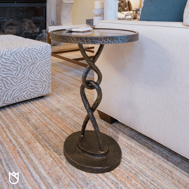 A Loop-de-Loop in hammered metal next to the sofa makes for the perfect place to set your wine glass during long talks in front of the fireplace