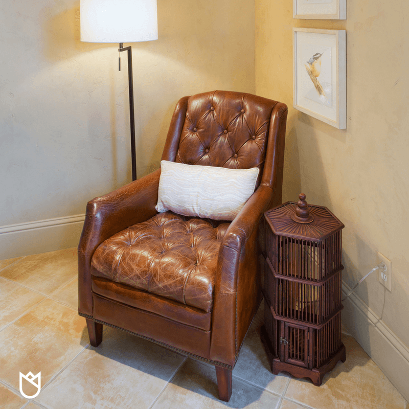 A lovely vintage leather chair is repurposed for a sweet little reading corner