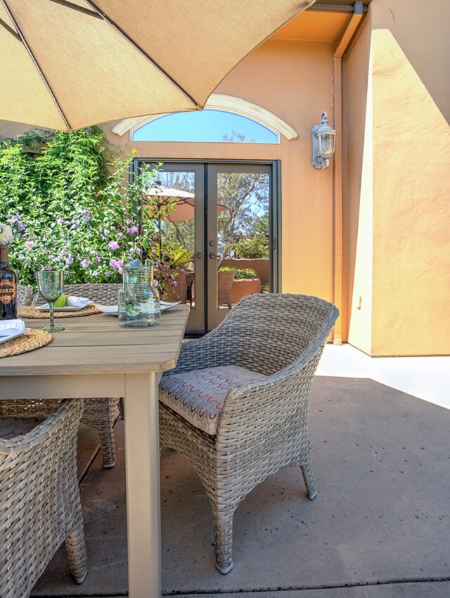 KTJ-Design-Co._Stockton-CA_Outdoor-Dining-Area-with-Cushioned-Wicker-Chairs-and-Umbrella-Table_How-to-Design-a-Social-Outdoor-Living-Space.jpg
