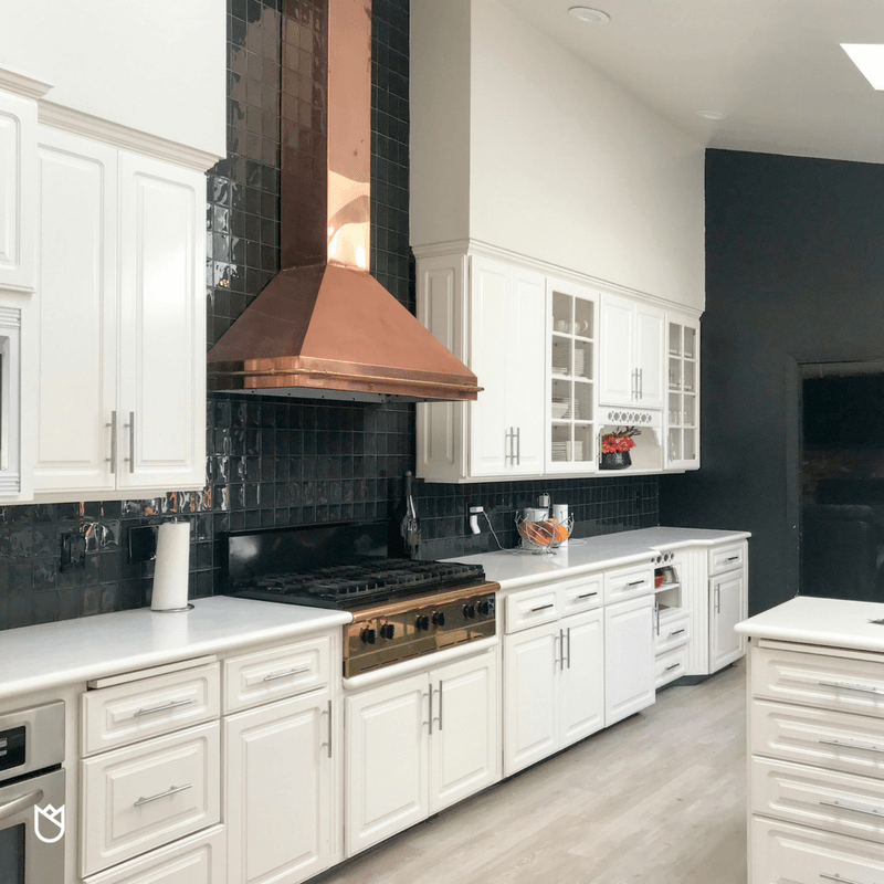 The first thing my eyes landed on was the magnificent copper and gold ventilation hood with a matching cooktop. There was no way I was letting my client demo these