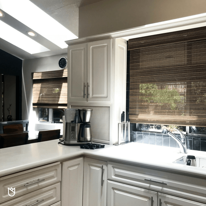 With so many sleek surfaces we needed a bit of texture. Boasting both texture and a natural wood element, woven wood Roman Shades are our favorite