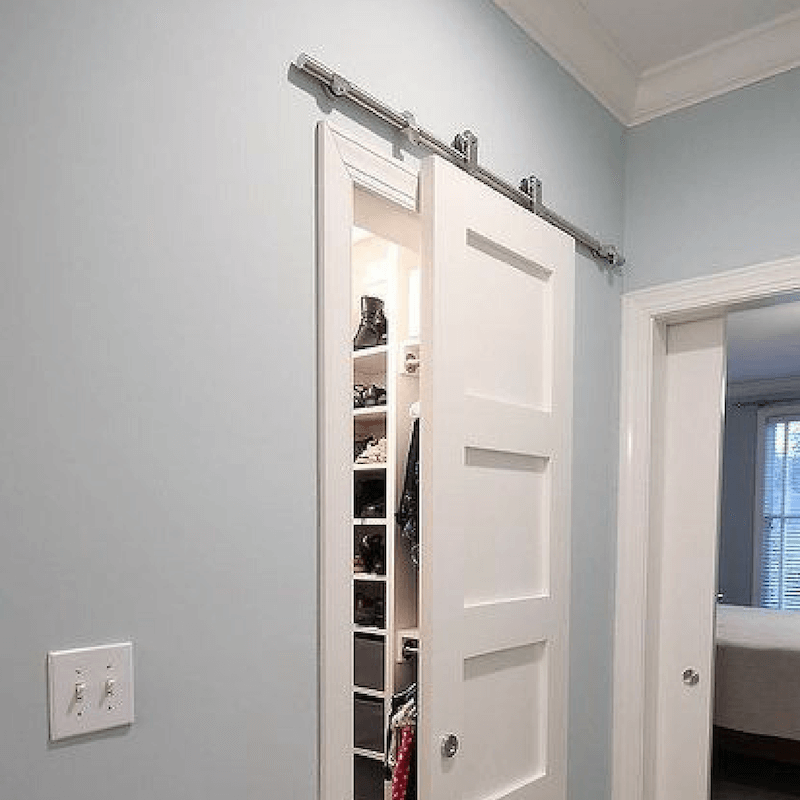 ditch those closet bypass doors and use barn doors instead for a truly professionally designed room