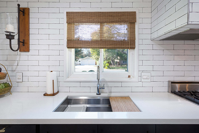 ktj-design-co-95219-new-blog-the-impressive-value-of-custom-window-treatment-white-woven-wood-roman-shade.jpg