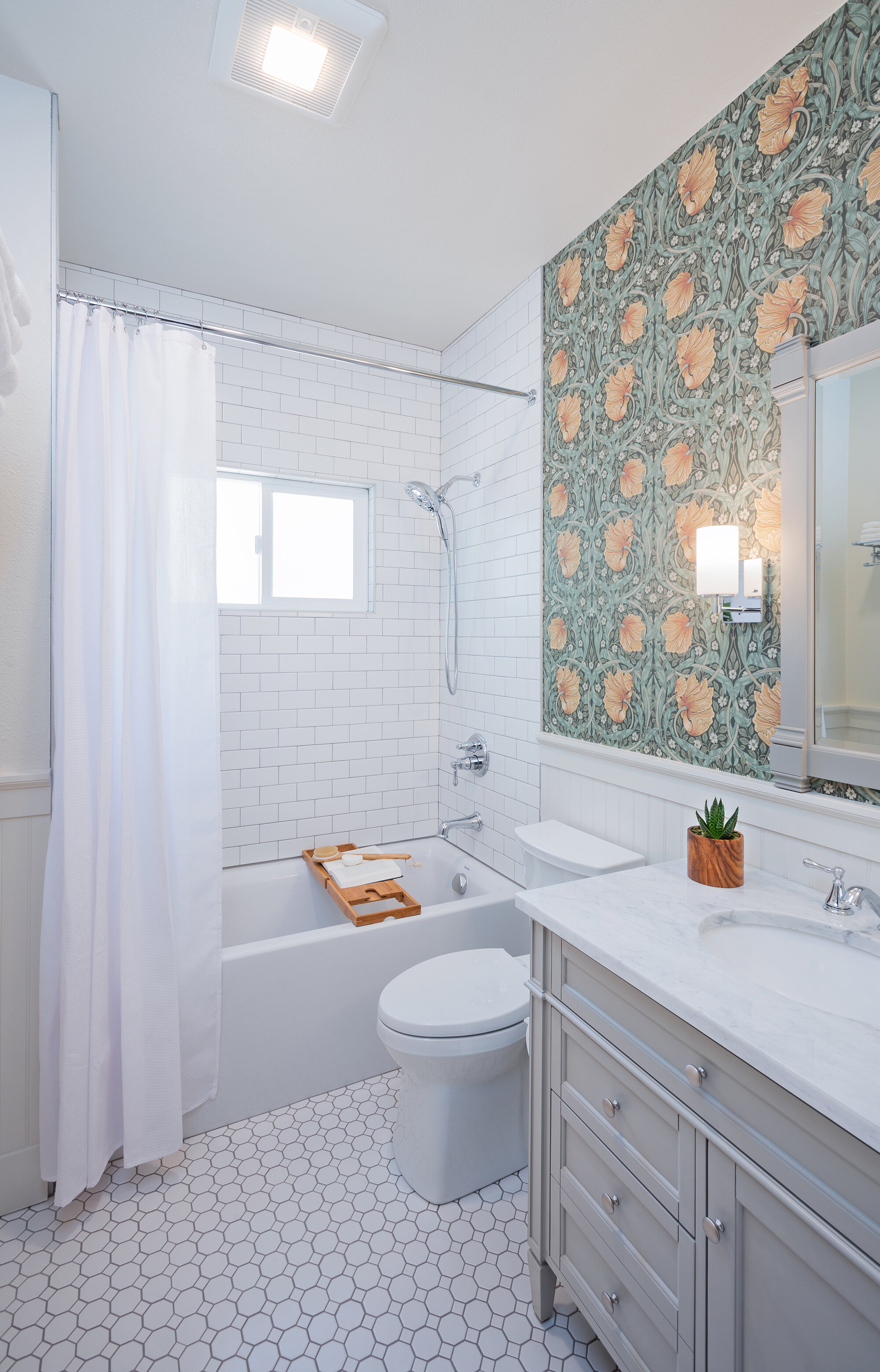 The William Morris wallpaper in this bathroom in a 1920’s bungalow is period perfect.