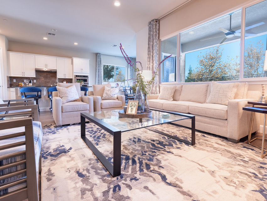 Notice how the area rug in the living room and dining room complement each other, bringing a wonderful cohesion to this open concept floor plan?!