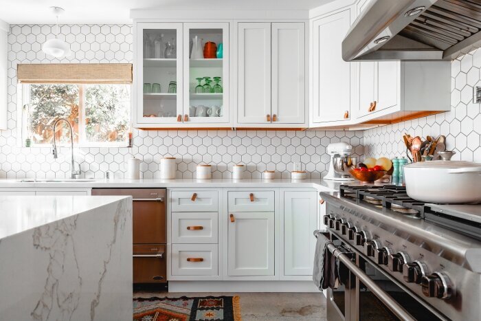 ktj-design-co-stockton-california-interior-designer-95219-white-kitchen-design-waterfall-counter-woven-shades-open-glass-cabinets.jpg