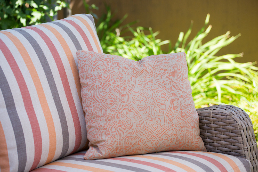 patio-sofa-accent-pillow-red-yellow-brown