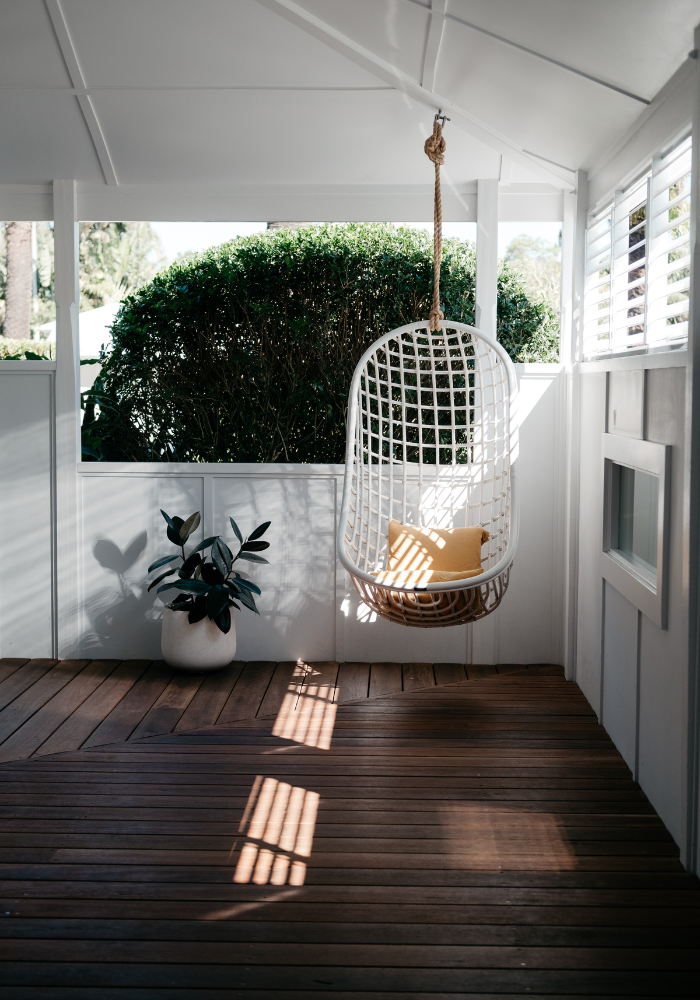 Covered Deck With Greenery Wood Flooring Hanging Swing With Pillow How To Design An Amazing Outdoor Space