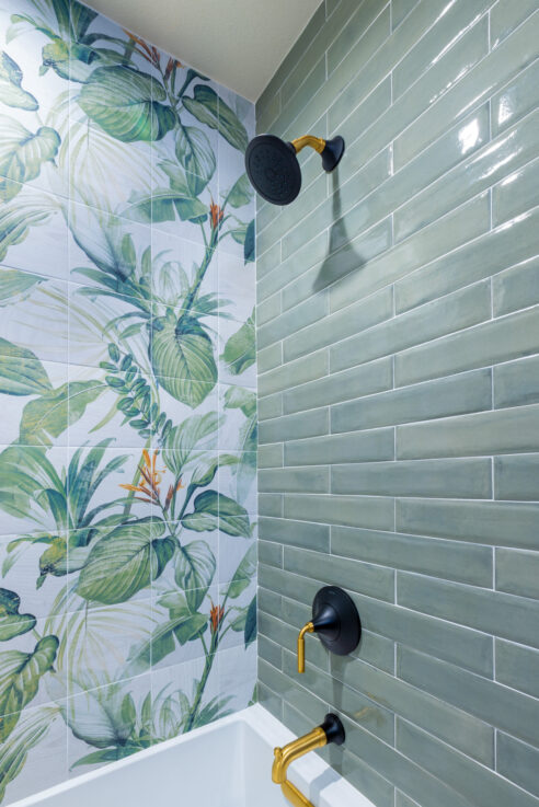 ktj-design-co-tub-shower-in-forest-inspired-bathroom-remodel-with-glossy-green-tile-and-large-scale-leaf-mural-accent-wall-95236-ho9a0170-2