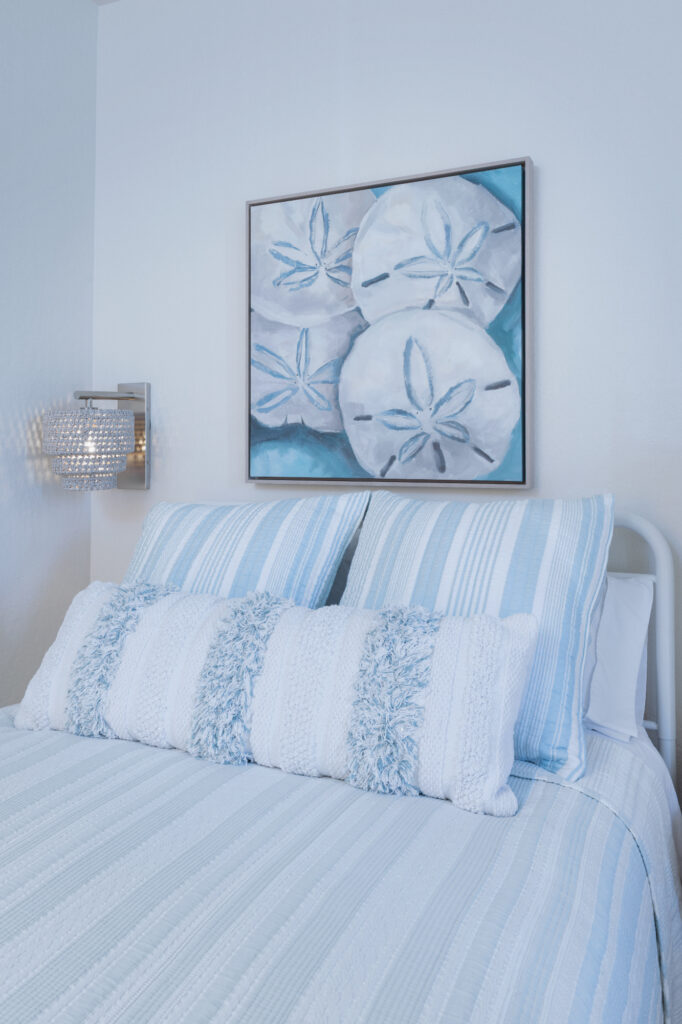 Santa Cruz Beach Condo Guest Bedroom With Blue Striped Bedding And Sand Dollar Coastal Artwork