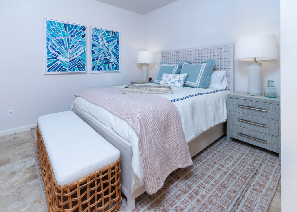 Santa Cruz Beach Condo Guest Bedroom With Woven Bench And Blue Coastal Artwork