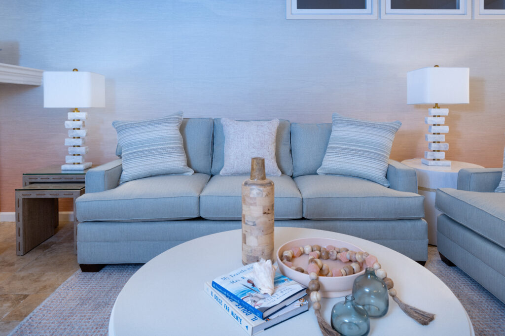 Santa Cruz Coastal Condo Living Room Styling With Round Coffee Table, Layered Decor, And Soft Blue Seating