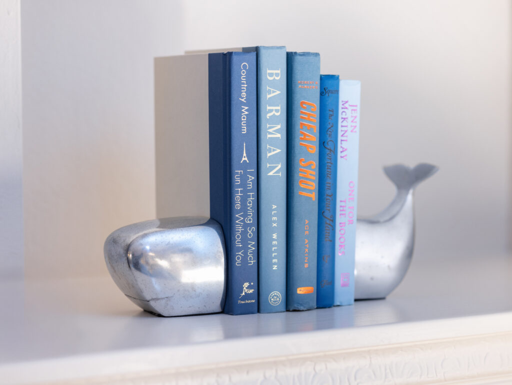 Santa Cruz Coastal Condo Styling With Blue Toned Books And Decorative Shelf Accessories
