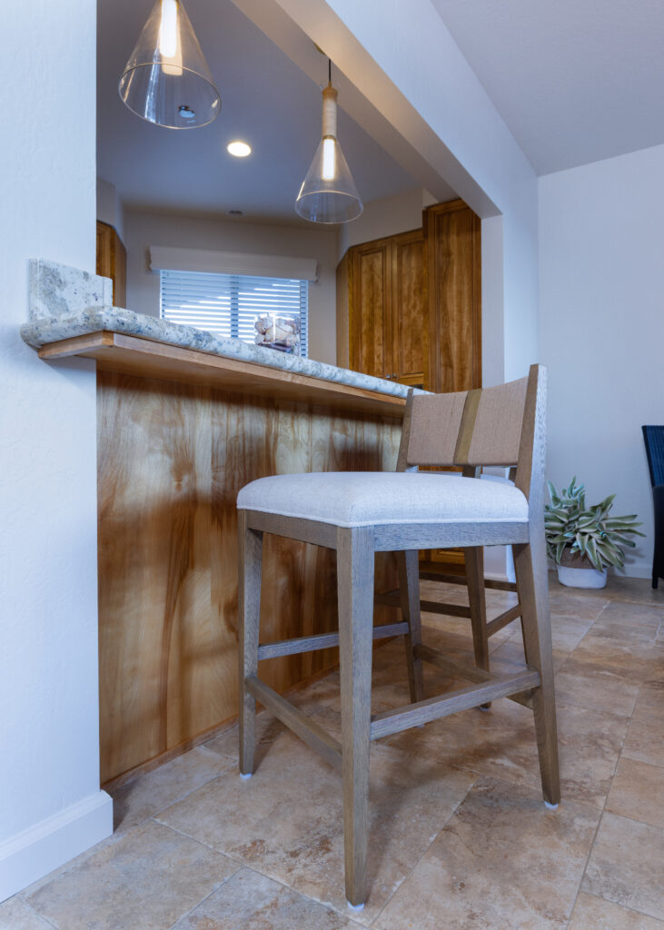 Santa Cruz Condo Kitchen With Wood Bar Stools Granite Countertops And Warm Wood Cabinetry