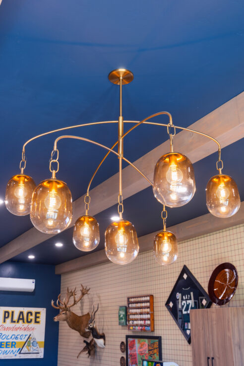 morada-ktj-design-co-gameroom-chandelier-brass-ombre-glass-wood-beams-plaid-wallpaper_ho9a1647