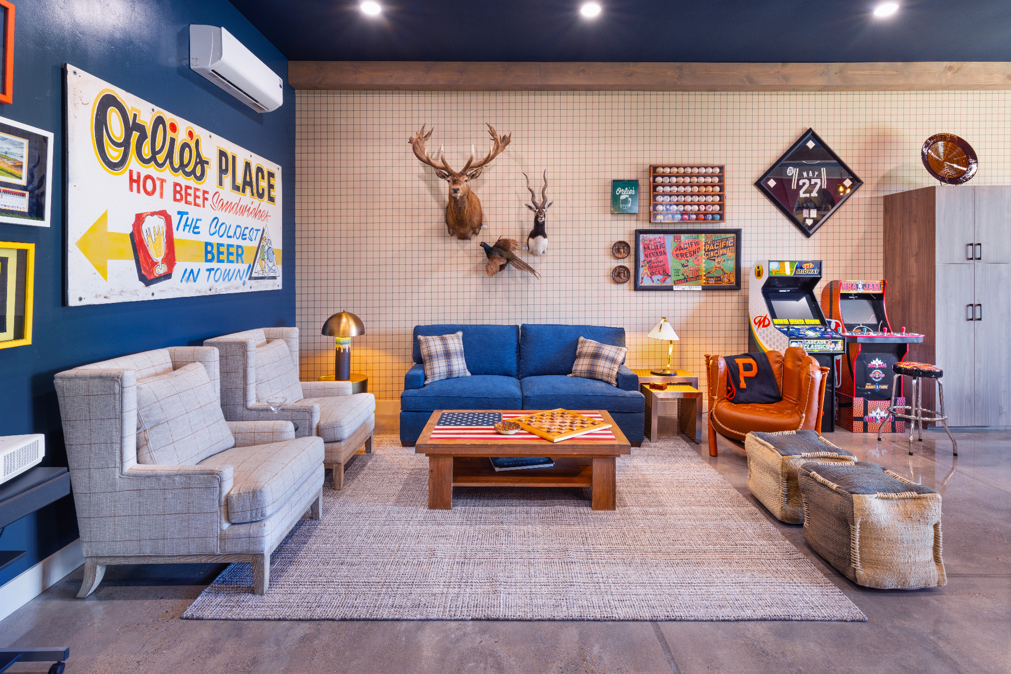 morada-ktj-design-co-gameroom-golf-seating-arcade-games-plaid-wallpaper-sofa-bed-navy-ceiling-polished-concrete_ho9a1319