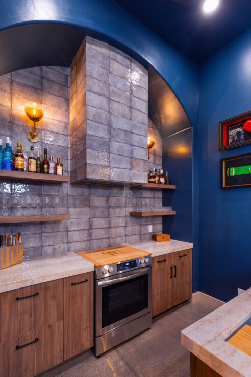 morada-ktj-design-co-gameroom-navy-arched-bar-emser-tile-exhale-gris-gray-tile-wynnbrooke-cabinets-wall-sconce-boxing-polished-concrete_ho9a1414