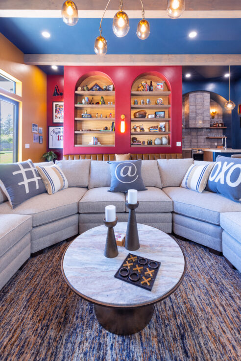 morada-ktj-design-co-gameroom-navy-ceiling-49er-red-arched-built-in-bookcase-gold-wallpaper-large-u-shaped-sectional-bar-kitchen-wood-beam_ho9a1390