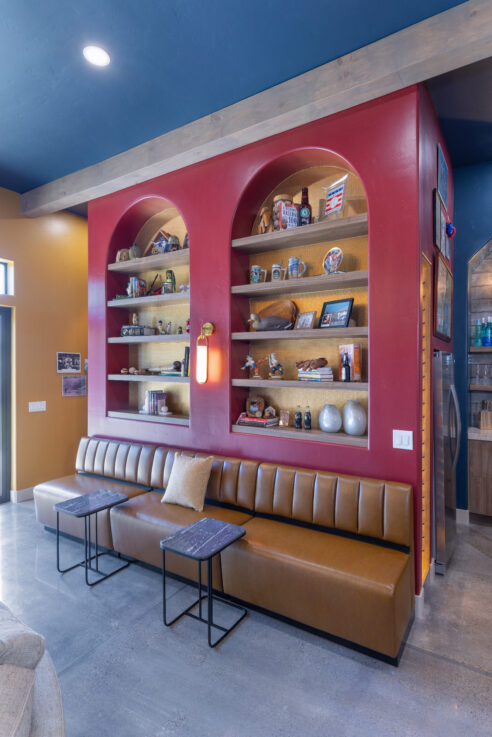 morada-ktj-design-co-gameroom-sports-bar-arched-bookshelf-built-in-bench-seating-red-wall-49er-red-gold-wallpaper-baseball-football_ho9a1251