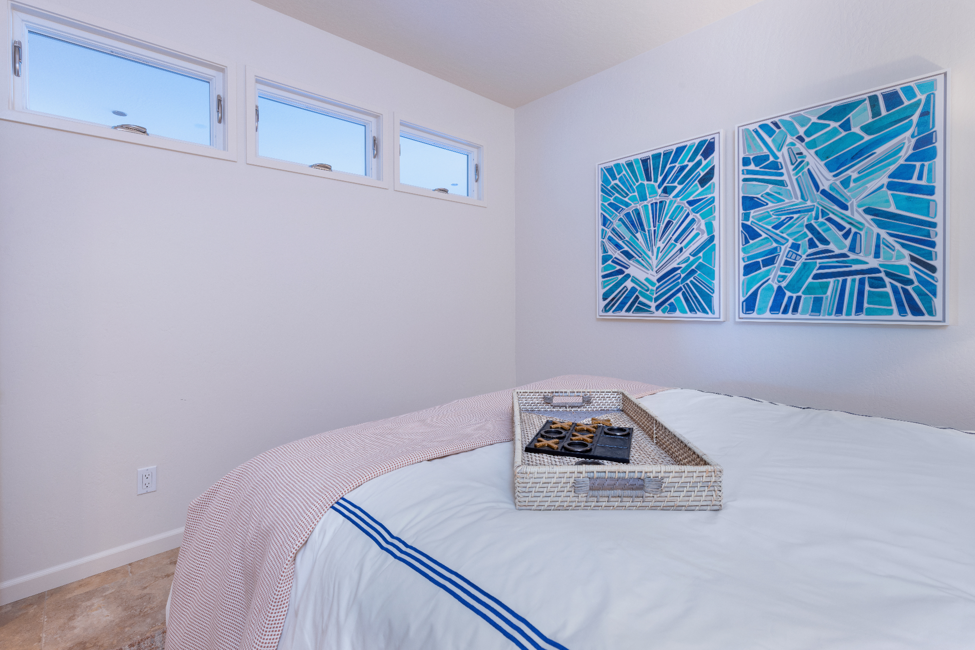 ktj-design-co-santa-cruz-beach-condo-guest-bedroom-tide-line-awning-bedroom-windows-shell-starfish-artwork-crisp-bedding_ho9a6611