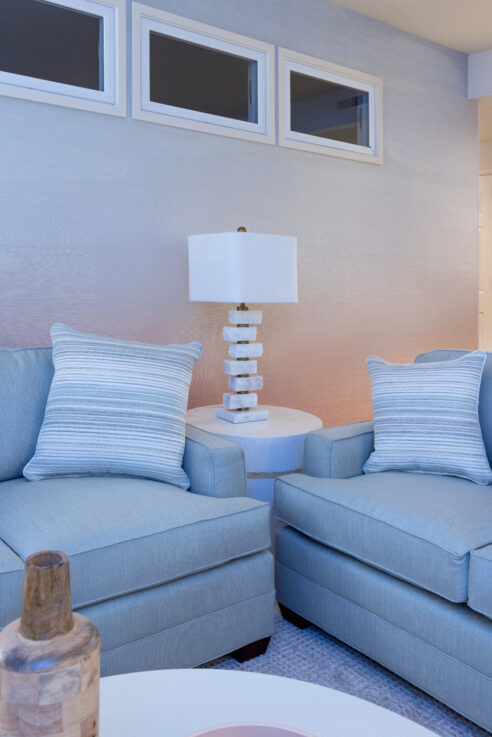 ktj-design-co-santa-cruz-beach-condo-living-room-blue-sofas-grasscloth-wallpaper-sunset-marble-table-lamp_ho9a6818