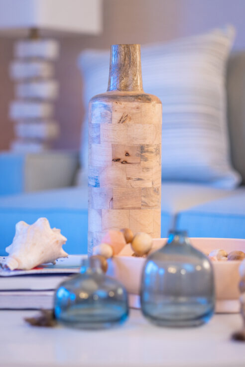ktj-design-co-santa-cruz-beach-condo-living-room-weathered-wood-vase-sea-glass-vases-shell-books-table-styling_ho9a6791