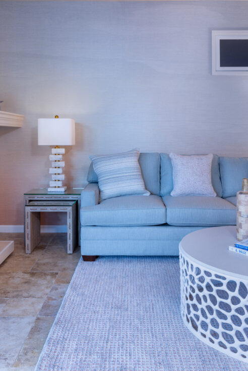 ktj-design-co-santa-cruz-beach-condo-tide-line-blue-sofa-coastal-woven-wood-nesting-tables-white-coral-coffee-table_ho9a6728