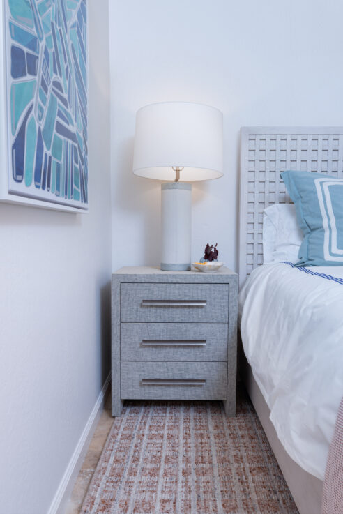 ktj-design-co-santa-cruz-beach-condo-tide-line-guest-bedroom-blue-woven-nightstand-blue-starfish-artwork-clay-area-rug_ho9a6637