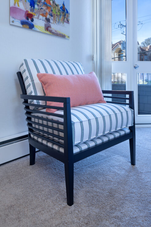 ktj-design-co-santa-cruz-tide-line-beach-condo-bedroom-wood-accent-arm-chair-blue-green-striped-coral-pillow_ho9a6411